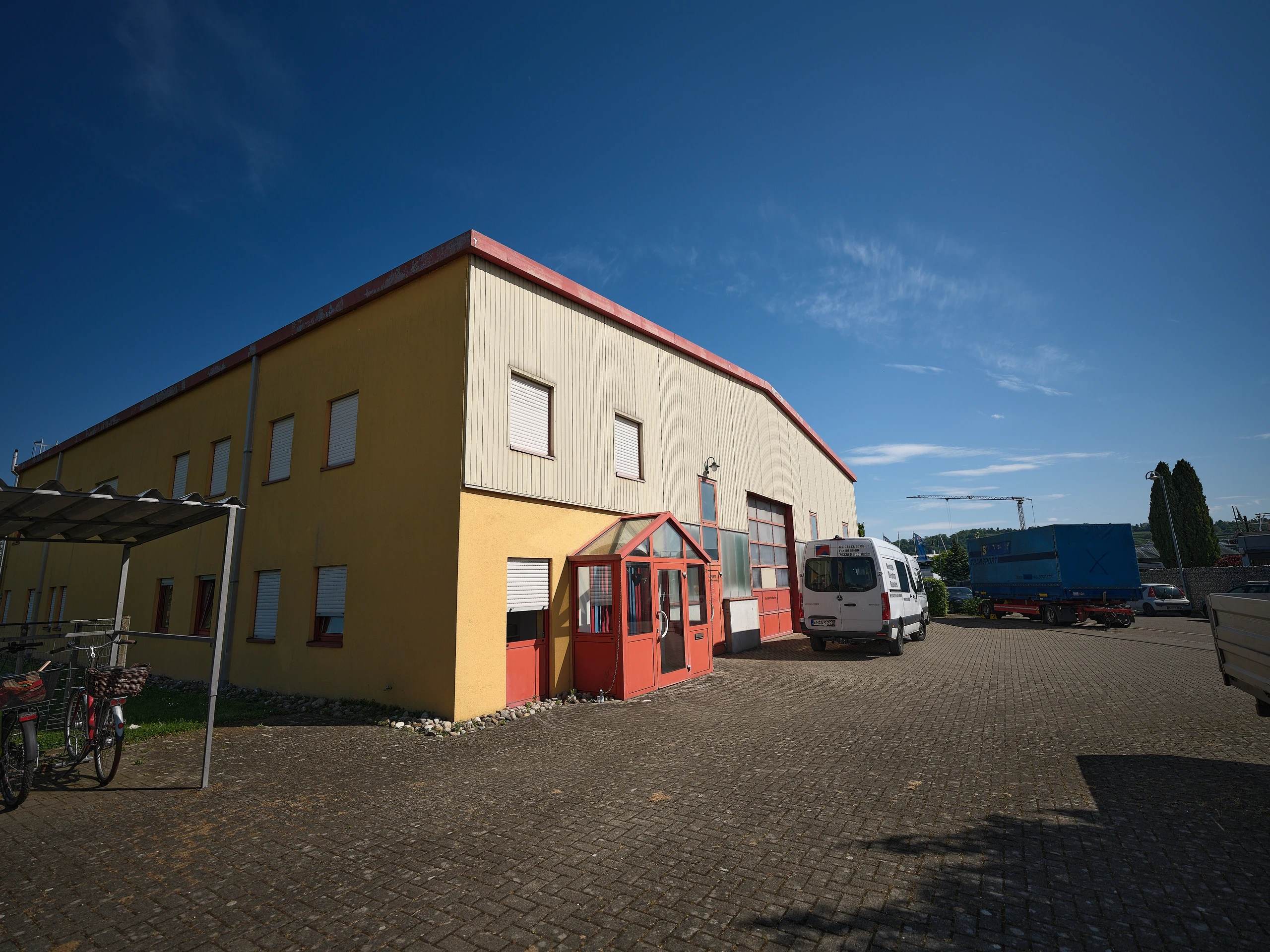 Rote Stahlträger der Hallenkonstruktion bei W & S Krantechnik